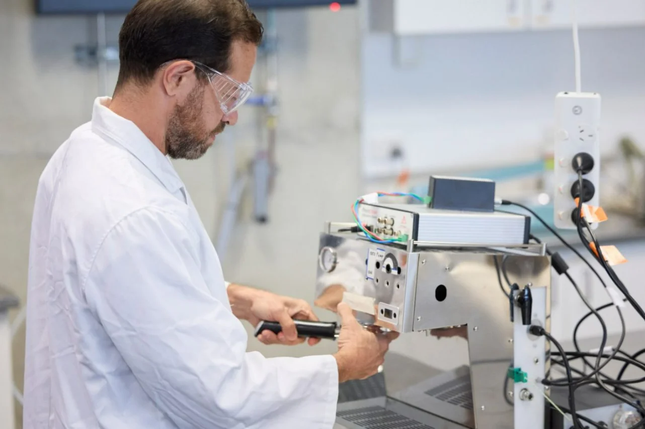Dr Francisco Trujillo holding a cup of ultrasonic coffee